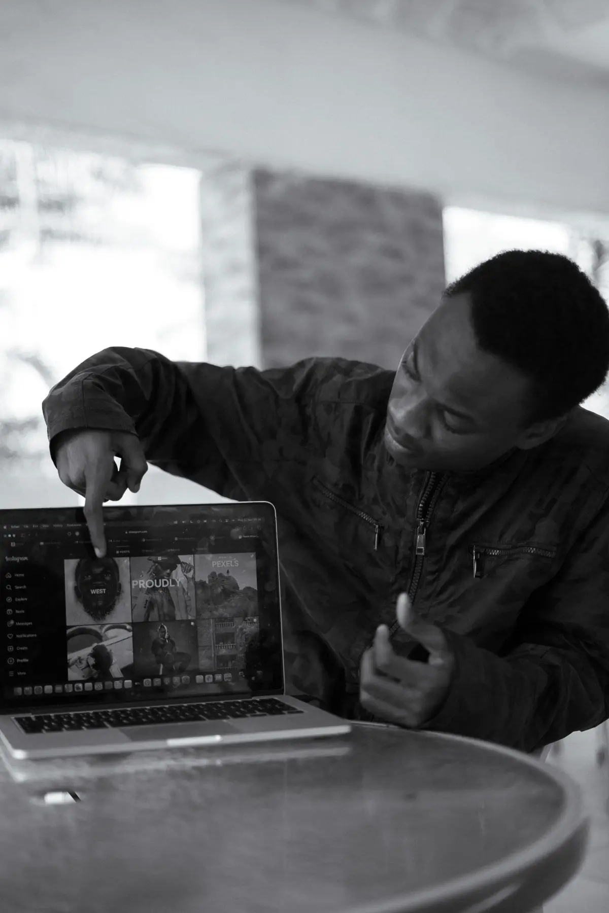 An engineer pointing at work on his laptop
